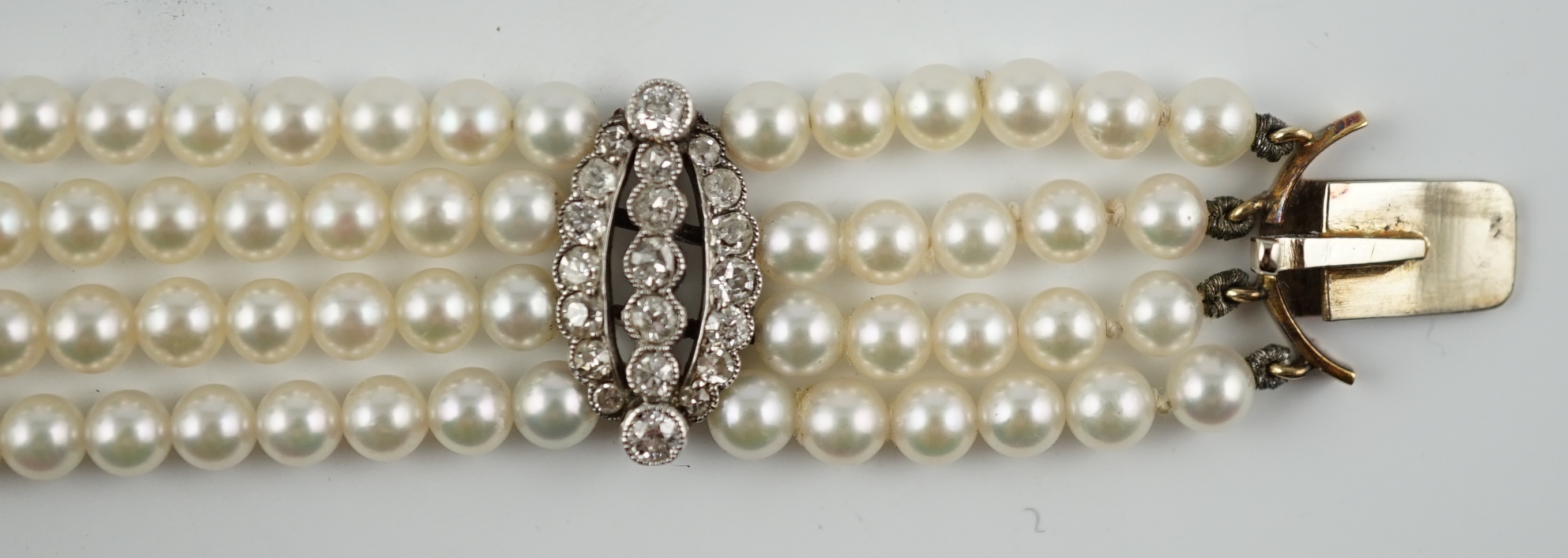 A multi-strand cultured pearl bracelet, with circular diamond cluster set gold clasp